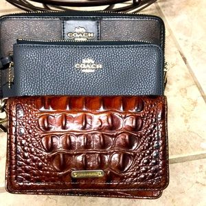 Three designer wallets, to coach wallets in one Brahmin wallet.
